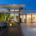 Modern waterfront home with outdoor living area at dusk