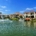Waterfront homes along a canal with a fountain