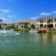 Waterfront homes along a canal with a fountain